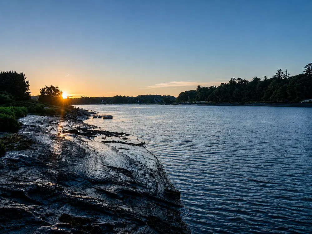 Sunset over the River Suir from a rocky shoreline